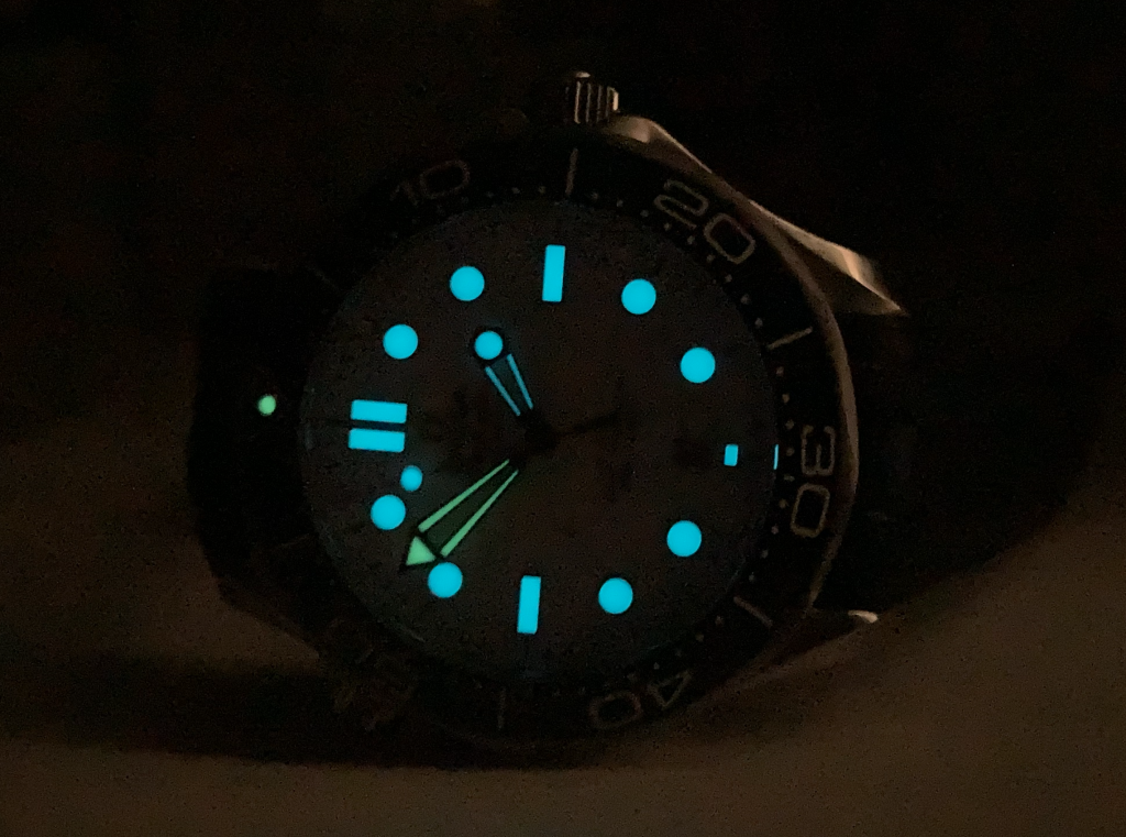The two-color lume is well executed with a green minute hand and bezel marker on blue lume indices